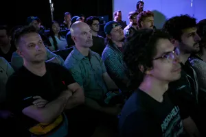 Una toma de una fila de miembros del público escuchando atentamente la presentación de la keynote.