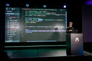 Ben Holmes hablando desde un podio de marca Astro. Está mirando el portátil. En pantalla hay un code example para un newsletter.