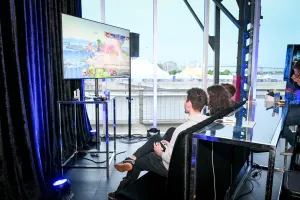 Invitados jugando a Super Smash Bros en el lounge de videojuegos.